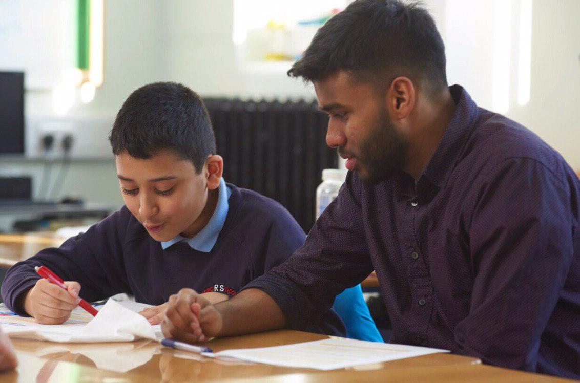 A primary school pupil being mentored by a university student 